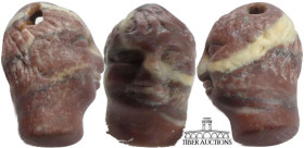 Roman. Carved Stone Head. 3rd- 5th century AD. Carved stone pendent of a young man's head. Beautifully executed. 27 mm x 15 mm, 4.74 g.