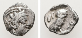 Attica, Athens. AR, Obol. 0.63 g. - 9.63 mm. Circa 454-404 BC.
Obv.: Head of Athena right, with frontal eye; wearing crested Attic helmet decorated wi...