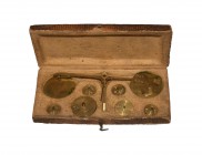World Coins - France - Cased Coin Balance Set
19th century AD. A set of brass balance and pans with silk suspension cords, together with circular bra...