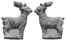 Weight 5,76 gr - Diameter 23 mm. An ancient Votif Roman bronze figurine of a Goat or Buck on a small base. The body is incised with curving lines to r...