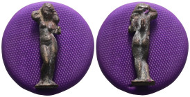 Weight 5,62 gr - Diameter 33 mm. Aphrodite (Venus) Anadyomene figure made of bronze; The goddess is depicted standing naked, holding two strands of he...