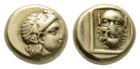 Lesbos, Mytilene EL Hecte. Circa 377-326 BC. 2.56 g. 10,56 mm.
Head of Dionysos facing right, wearing ivy-wreath / Mask of Silenos facing in thin squa...