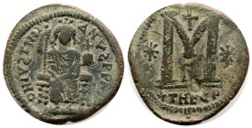 Justinian I. 527-565. Æ Follis (32mm, 17.3 g, ) Theoupolis (Antioch) mint,  Justinian enthroned facing, holding scepter and globus cruciger / Large M ...