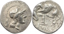 Greek Italy. Southern Apulia, Caelia. AR Diobol, 325-275 BC. D/ Head of Athena right, wearing Attic helmet decorated with Scylla. R/ Herakles kneeling...