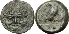 Sicily. Kamarina. AE Tetras, 425-405 BC. D/ Facing gorgoneion. R/ KAMA. Owl standing right, head facing, grasping lizard; in exergue, three pellets. C...