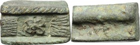 Aes Premonetale. Stylized astragalus-shaped (?) AE Cast Ingot, decorated with rosette in incuse square, 4th-3rd century BC. AE. g. 71.50 RR. mm. 32x20...