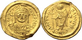 Justinian I (527-565). AV Solidus, Constantinople mint, 545-565 AD. D/ DN IVSTINIANVS PP AVI. Helmeted and cuirassed bust facing, holding globus cruci...