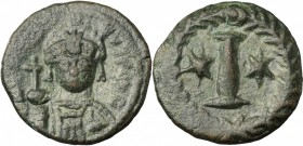 Justinian I (527-565). AE Decanummium. Rome mint, circa 547-549. D/ Helmeted and cuirassed facing bust, holding globus cruciger and shield. R/ Large I...