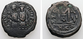 Justin II and Sophia, AD 565-578. AE, Follis. 12.50 g. 29.52 mm. Nicomedia.
Obv: DNIVSTI-NVSPPAVC. Justin II on left and Sophia on right, seated, nimb...