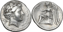 Greek Italy. Bruttium, Terina. AR Drachm, c. 300 BC. Obv. ΤΕΡΙΝΑΙΩΝ. Head of nymph right; triskeles behind. Rev. Nike seated left on plinth, holding k...