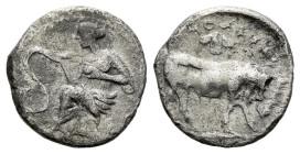 Sicily, Selinus Litra circa 410, AR 11.00 mm., 0.73 g.
Nymph seated l. on rock, touching serpent to l. Rev. Man-headed bull standing r.; selinon leaf...