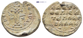 BYZANTINE LEAD SEAL. (23mm, 7.5 g) Obv: Patriarchal cross, with central cross in saltire, set upon base of two steps; floral scrolls around. Rev: Lege...