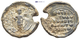 BYZANTINE LEAD SEAL. (28mm, 14.9 g) Obv: Nimbate archangel Michael, with spread wings, standing facing, holding spear.. Rev: Legend in 5 lines.