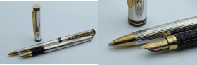 WATERMAN -Lotto di 2 penne- Stilografica e Portamine. Corpi argentati con finiture nere e dorate. Stilografica con ricarica a cartuccia e pennino F in...