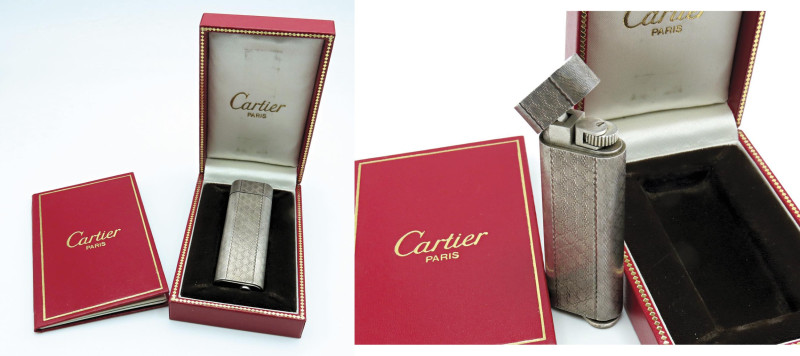CARTIER. Accendino. Numero di serie 8 3031E. Corpo in argento. Alto 7cm, largo 2...