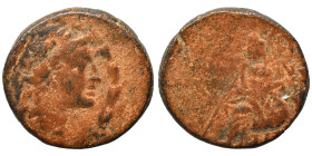 Greek. Ae (bronze, 8.08 g, 21 mm). Laureate head right, within wreath. Rev. Zeus (?) seated left. Repatinated, fine.