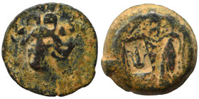 Greek. Ae (bronze, 3.62 g, 15 mm). Gorgoneion facing. Rev. Nike standing left; c/m (anchor). Fine.