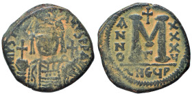 Justinian I, 527-565. Follis (bronze, 17.93 g, 33 mm), Theoupolis (Antioch). Helmeted and cuirassed bust facing, holding globus cruciger and shield; c...