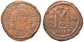 Justinian I, 527-565. Follis (bronze, 19.62 g, 40 mm), Nicomedia. Helmeted and cuirassed bust facing, holding globus cruciger, shield on left shoulder...