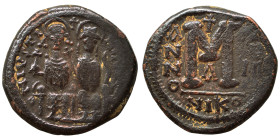 Justin II, with Sophia, 565-578. Follis (bronze, 12.73 g, 28 mm), Nicomedia. Justin, holding globus cruciger, and Sophia, holding cruciform scepter, s...
