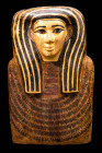 EGYPTIAN WOODEN SARCOPHAGUS LID WITH GILDED MASK

 Later Period, 26th Dynasty, Ca. 664 - 525 BC A large and finely carved Egyptian wooden sarcophagu...