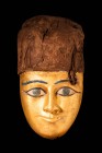 EGYPTIAN GILDED MASK WITH OBSIDIAN EYES

Late Period, Ca. 713 - 332 BC A sarcophagus gilt mask carved from finely-grained cedar wood. The almond-sha...