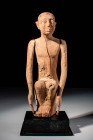 EGYPTIAN WOODEN PAINTED SEATED MAN 

 Middle Kingdom, 11th to 12th Dynasty, Ca. 2055 - 1790 BC An Egyptian carved wooden seated figure of a domestic...