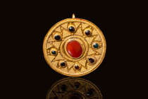 HELLENISTIC GOLD BROOCH WITH RED JASPER CABOCHON

 Ca. 100 BC - AD 100 A Hellenistic gold circular brooch made of a thin sheet of gold, decorated wi...