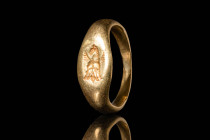GREEK GOLD RING DEPICTING A PEGASUS

 Ca. 500 - 400 BC A Greek gold ring with an elongated bezel depicting a front-facing Pegasus with a raised head...