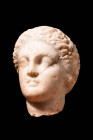 GREEK MARBLE HEAD OF YOUTH

 Ca. 400 - 300 BC A Greek marble head of a youth, expertly sculpted with fine details to appear stylised. Capped with a ...