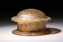 HELLENISTIC YELLOW GLASS PYXIS WITH LID

 Ca. 200 - 50 BC A Hellenistic mould-blown pale yellow glass pyxis with a cylindrical form. The vessel has ...