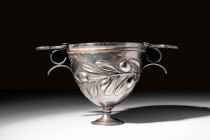 ROMAN SILVER TWO-HANDLED SKYPHOS WITH OLIVE BRANCH

 Ca. 100 BC - AD 100 A Roman solid silver two handled skyphos, with thick straight walls and a s...
