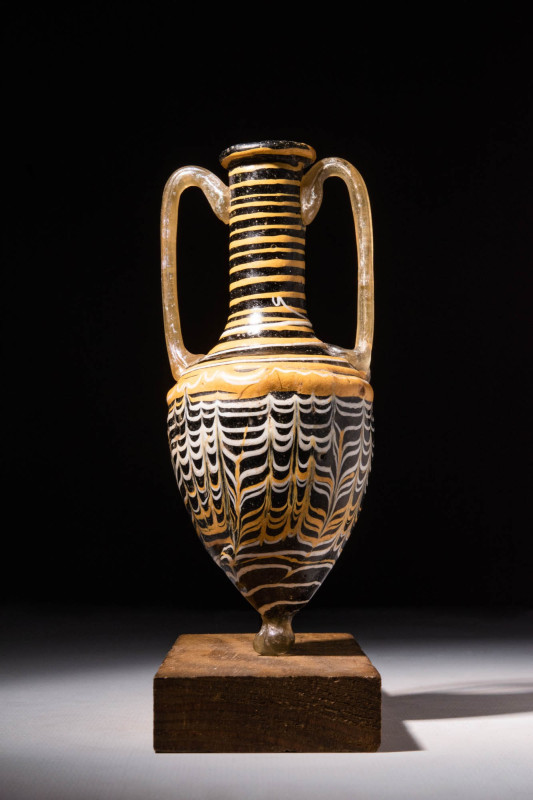 STUNNING CORE-FORMED GLASS AMPHORISKOS

Ca. 200 BC - AD 100 A superb Eastern M...