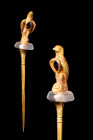 ROMAN LEGIONARY GOLD PIN WITH EAGLE

 Ca. 300 - 100 BC A Roman gold pin with a long tapered body and an acanthus leaf decoration at the top. The hea...