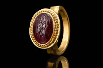 ROMAN GOLD RING WITH INTAGLIO DEPICTING MARS 

 Ca. 300 - 100 BC A Roman gold ring with intaglio depicting the war God Mars represented naked wearin...