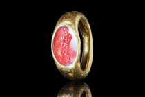 ROMAN GOLD RING WITH CARNELIAN INTAGLIO DEPICTING A SATYR

 Ca. AD 50 - 200 A Roman gold ring with a carnelian intaglio depicting a satyr playing a ...