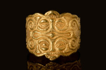 CELTIC GOLD RING DECORATED WITH A CROSS

 Ca. 500 - 400 BC A stunning Celtic gold ring where the flat section of the band widens on the shoulders to...