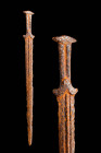 SCYTHIAN ACINACES IRON DAGGER WITH COMPLETE HANDLE AND CHAPE

 Ca. 600 - 200 BC A Scythian iron acinaces dagger featuring a short, double-edged blad...