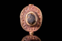 HELLENISTIC GOLD ROUND PENDANT WITH CENTRAL CABOCHON

 Ca. 300 - 100 BC A high-quality ancient gold and garnet pendant with a round shape and a thic...