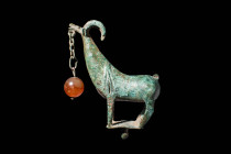 TRANS CAUCASIAN BRONZE GOAT-SHAPED FINIAL WITH SUSPENDED CARNELIAN BEAD

 Ca. 1300 - 1200 BC A bronze mountain goat statuette from the Transcaucasia...