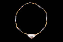 BACTRIAN NECKLACE WITH BANDED AGATE BEADS

 Ca. 2250 - 1700 BC An elegant Bactrian necklace featuring six bi-conical elongated beads of an amazing b...