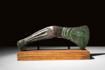 SUPERB BACTRIAN BRONZE BATTLE AXE

 Ca. 2500 - 2000 BC A Bactrian bronze votive axe that would have been placed atop a standard for ceremonial purpo...