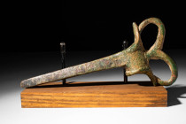 WESTERN ASIATIC BRONZE AXE WITH A HEAD OD STAG

 Ca. 1200 - 800 BC A bronze socketed axe head with a circular socketing hole, a slender pickaxe-like...