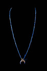 WESTERN ASIATIC LAPIS LAZULI NECKLACE WITH A CRESCENT PENDANT

 Ca. 3000 - 2500 BC A Western Asiatic necklace with lapis lazuli seed-shaped beads em...