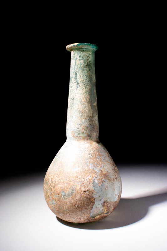 TALL ROMAN GLASS UNGUENTARIUM

 Ca. AD 100 - 400 A Roman white glass unguentar...