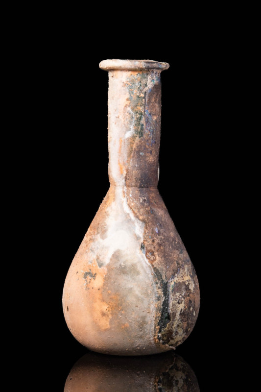 ROMAN GLASS UNGUENTARIUM

 Ca. AD 100 - 200 A Roman glass unguentarum with ama...