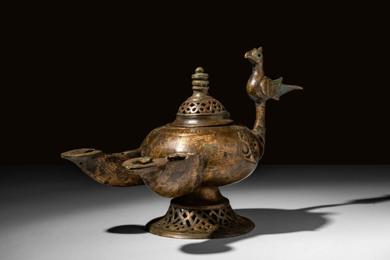 SELJUK BRONZE DOUBLE OIL LAMP WITH A BIRD

 Ca. AD 900 - 1100 A Seljuk bronze ...