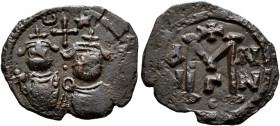 ISLAMIC, Time of the Rashidun. Pseudo-Byzantine types. Fals (Bronze, 21 mm, 2.84 g, 11 h), uncertain mint, circa 29-49 AH / 650-670 AD. Two bearded im...