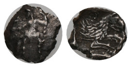 LYCAONIA, Laranda. Obol (324/3 BC). AR. Silver Obv: Baal seated left, torso facing, holding grain ear, grape bunch, and scepter Rev: Forepart of wolf ...