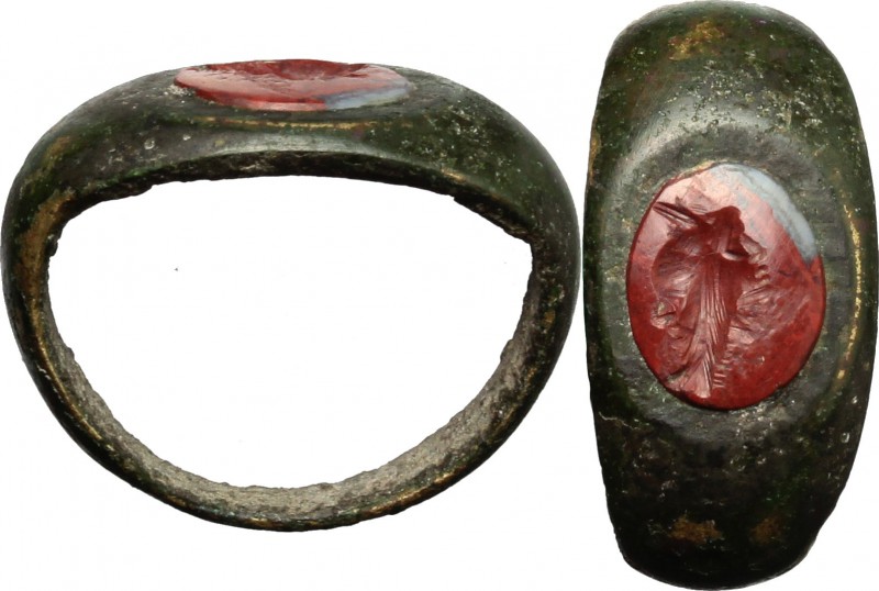 Bronze ring with carnelian intaglio engraved with 'grillos' (two joined faces). ...